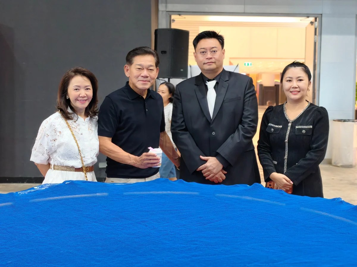 ผู้ร่วมงานถ่ายภาพร่วมกันข้างบ่อประกวดปลาคาร์ฟ